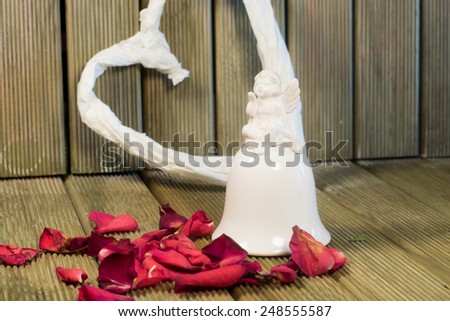 Hearth and angel figurine with rose petals