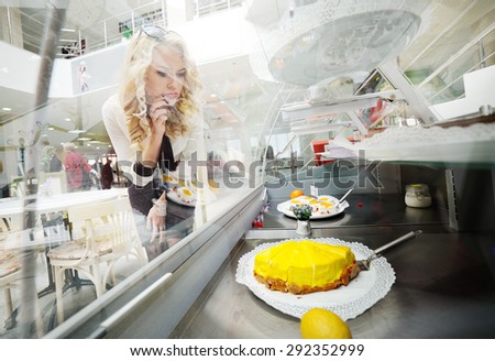 pretty hungry girl looking at tasty cake