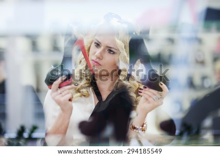 beautiful girl chooses shoes in a shoe store