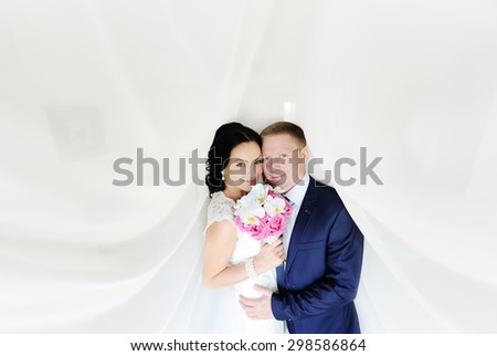 the bride and groom on a white background. the bride with a wedding bouquet of orchids
