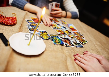 Divination by the Tarot cards. The fortune teller predicts the fate of the cards