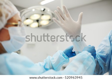 surgeon\'s hands in gloves closeup. Surgeons team preparing for a complex operation.