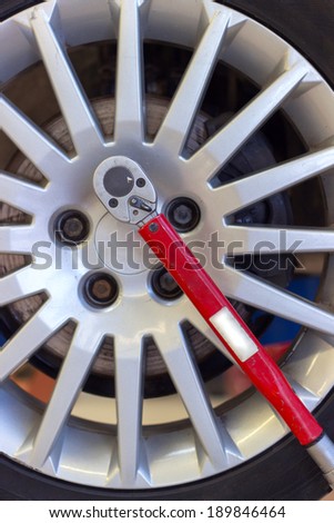 changing tire with wheel torque wrench