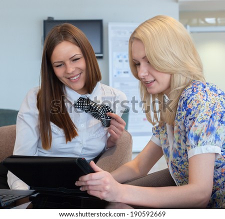 Two Businesswomen Meeting In Office with tablet pc.
