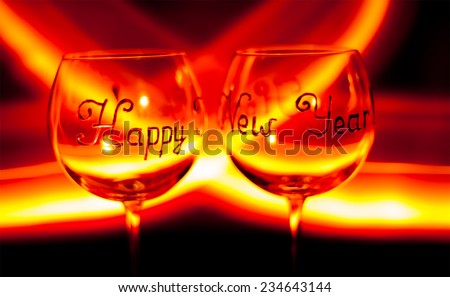 background - Happy new year`s eve  wine glass against fire