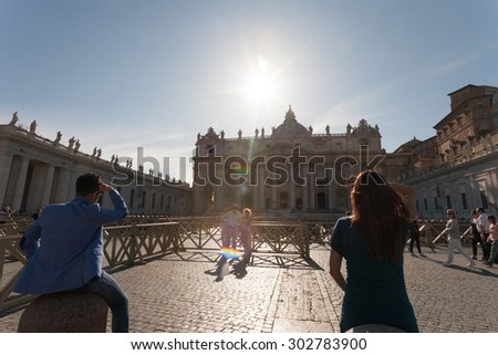 ROME, ITALY, April, 2015: Tourists looking at the facade of Saint Peter\'s Basilica in a sunny day.