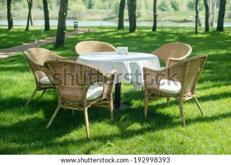 Open air restaurant with wood chairs in the forest