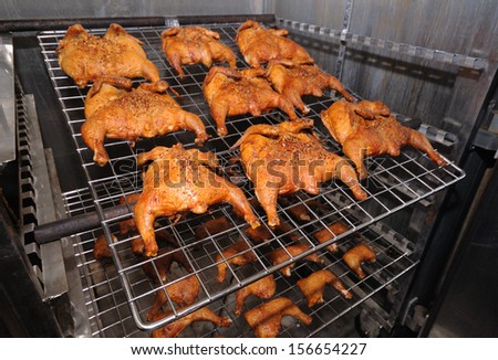 Batch of roasted chickens in the open electric oven