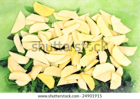 Cut potatoes on the green glass cutting board
