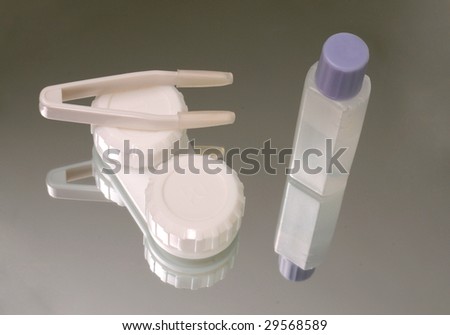 Contact lens storage, plastic tweezers and travel size container for solution on the mirror surface