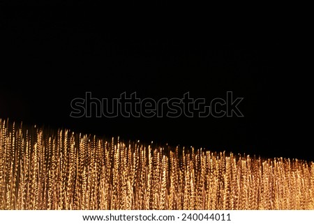 digitally generated image of gold light and stripes moving fast over black background