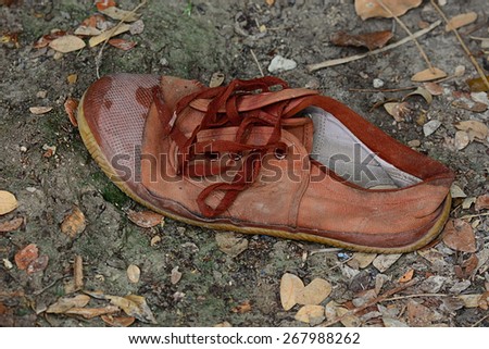 old brown shoes that were left on the dirty floor