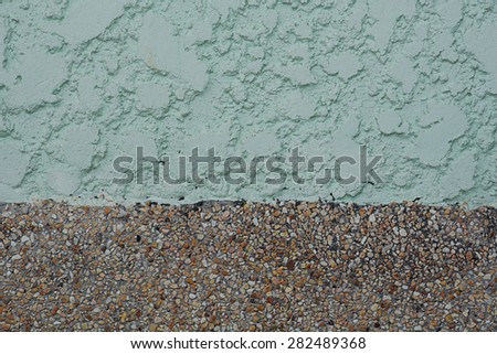 The wall of sand texture and green stucco background