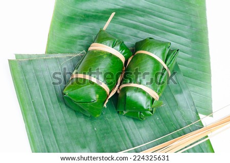 Thai dessert sticky rice steamed in banana leaf ( Khao Tom Mat ) with line bamboo on banana leaf