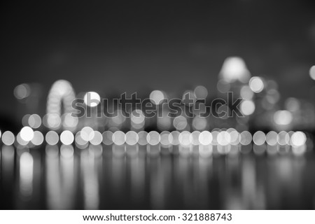 Singapore city night lights bokeh and reflect of marina bay blurred black and white background