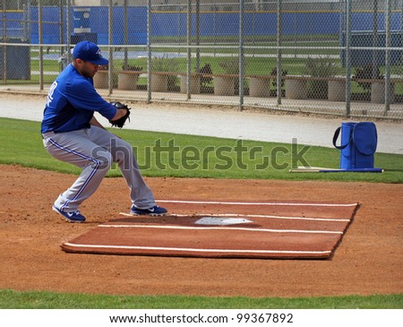 DUNEDIN, FLORIDA - FEBRUARY 25: Ricky Romero makes the play at home plate during Spring Training on February 25, 2012.  Romero will be the ace starter for the Toronto Blue Jays.