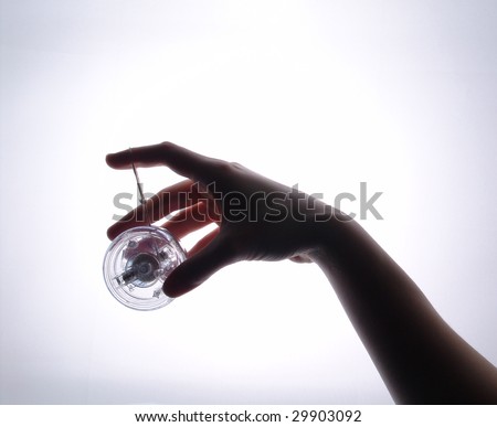 Silhouette of a hand holding a yo-yo toy.