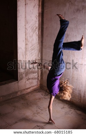 Girl doing handstand/falling. (The model is actually jumping upwards in this photo; what appears to be the floor is actually a ceiling.)