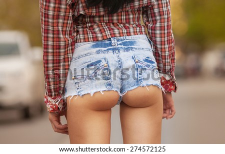 Sexy woman body in jean shorts. The model is back. Lonely girl .