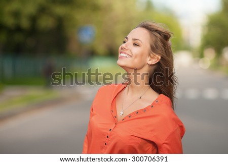 Surprised woman, delight, joy. Portrait of a woman on the street. Joy, positive emotions. Happy face. Open mouth. A woman in a hat. Green trees, summer, park