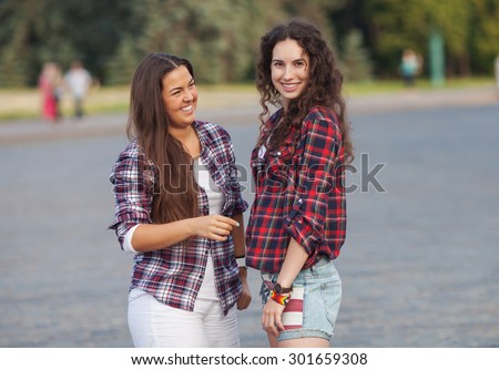 Two young woman making fun on nature at sunset