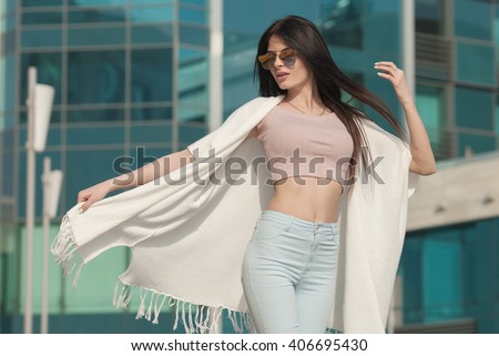 Portrait Of Young Beautiful Woman. beautiful young brunette fashion model posing outdoor. Summer outdoor portrait. Focus on woman, blurred background.