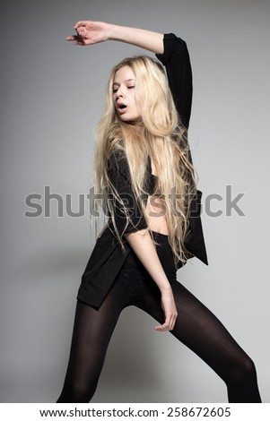 sexy blond fashion model with long hair, young European attractive, beautiful eyes, full lips, perfect skin is posing in studio for glamour vogue test photo shoot showing different model poses