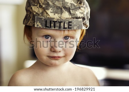 2 year old boy wearing his mother\'s old Army ACU cap--image taken indoors using natural light (Reno, Nevada, USA)
