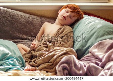 4 year old boy sleeping in his bed with a fever -- image taken in Reno, Nevada, USA