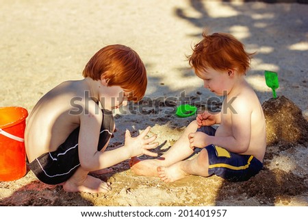 4 and 2 year old brothers playing at a park -- image taken at Sparks Marina Park in Sparks, Nevada, USA