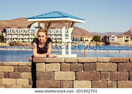 Tween girl playing at a park with her family -- image taken at Sparks Marina Park in Sparks, Nevada, USA