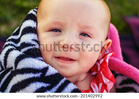 2 month old baby girl wrapped in a blanket at a park -- image taken at Sparks Marina Park in Sparks, Nevada, USA