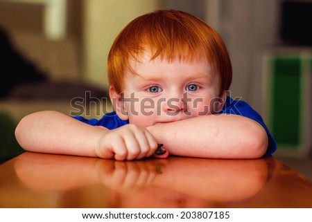 2 year old boy playing at a wooden table -- image taken indoors in Reno, Nevada, USA