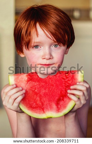 7 year old boy eating watermelon -- image taken in Reno, Nevada, USA