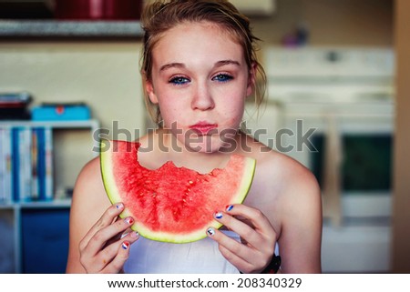 Tween girl eating a watermelon -- image taken in Reno, Nevada, USA
