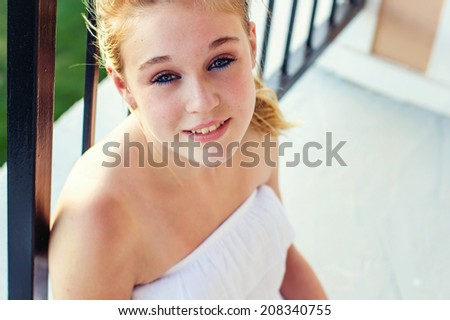 Tween girl in a white dress on the patio -- image taken in Reno, Nevada, USA