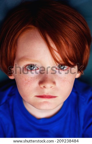 7 year old boy sitting outside on the patio -- image taken in Reno, Nevada, USA