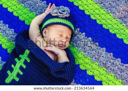3 week old baby outside in a handmade/crocheted Seattle Seahawks bunting and hat -- image taken in Reno, Nevada, USA
