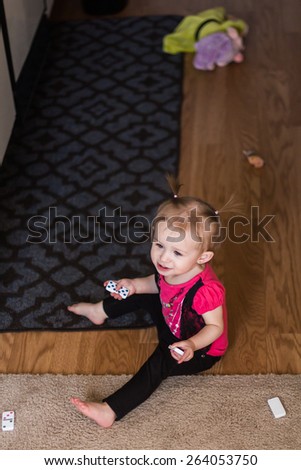 Baby girl playing on the floor in her home. Photo taken inside in Reno, Nevada, USA using natural window light.