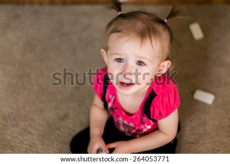 Baby girl playing on the floor in her home. Photo taken inside in Reno, Nevada, USA using natural window light.