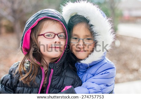 Young sisters playing outside together at a park in Reno, Nevada, USA.