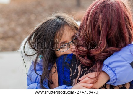 Mother holding her young daughter at a park in Reno, Nevada, USA.