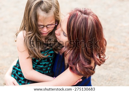 Mother comforting her daughter after getting hurt at a park in Reno, Nevada, USA.