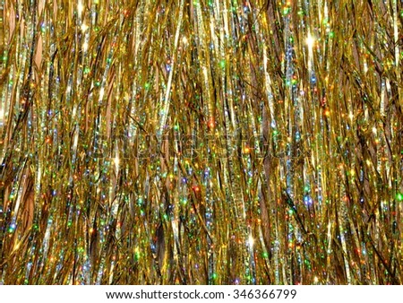 Sparkle, glitter, shimmer, gold colored festive holiday backdrop, background.  Abstract metallic gold strands.