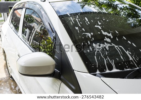 soap bubbles on car window before car wash