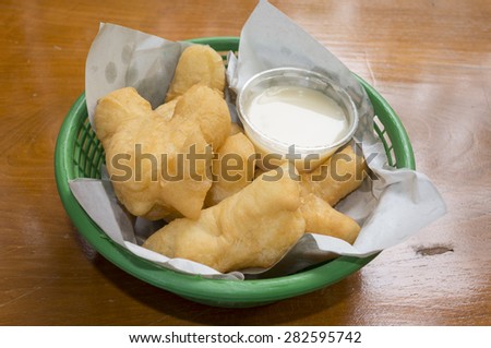 Breakfast in Thailand deep-fried doughstick and milk  on wood table background, close-up