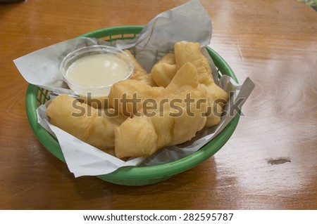 Breakfast in Thailand deep-fried doughstick and milk  on wood table background, close-up