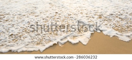 Sea wave and many foot print  on the beach background