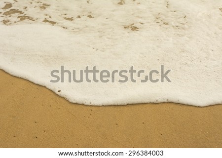 Sea wave and many foot print on the beach background,Soft-Focus