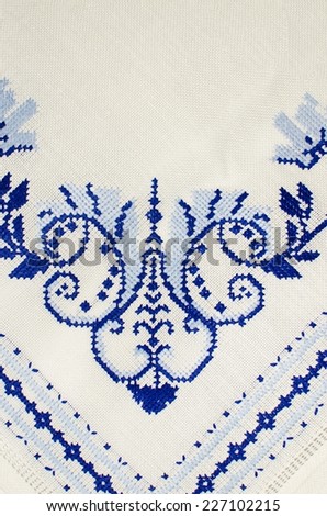 Cross stitch floral pattern on white cloth